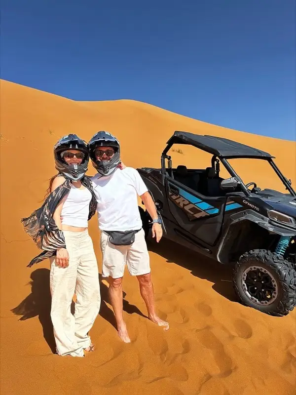 Couple standing next to their buggy
