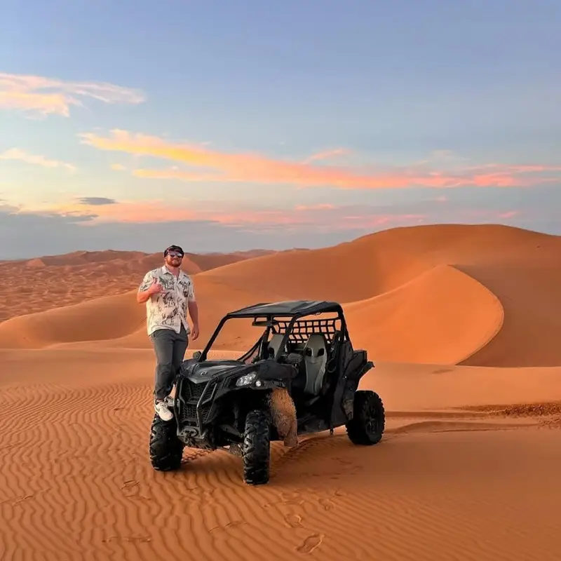 Buggy in the dunes at sunset