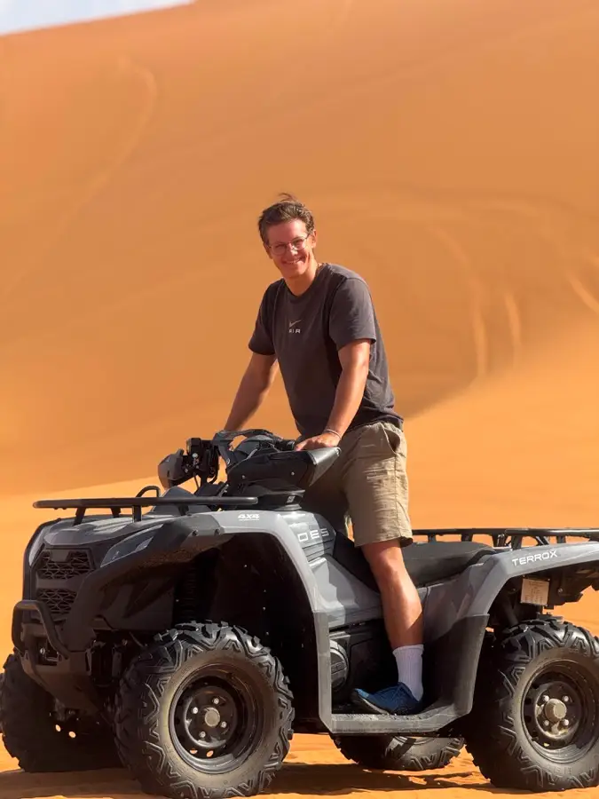 Man on a quad bike on the golden dunes of Merzouga