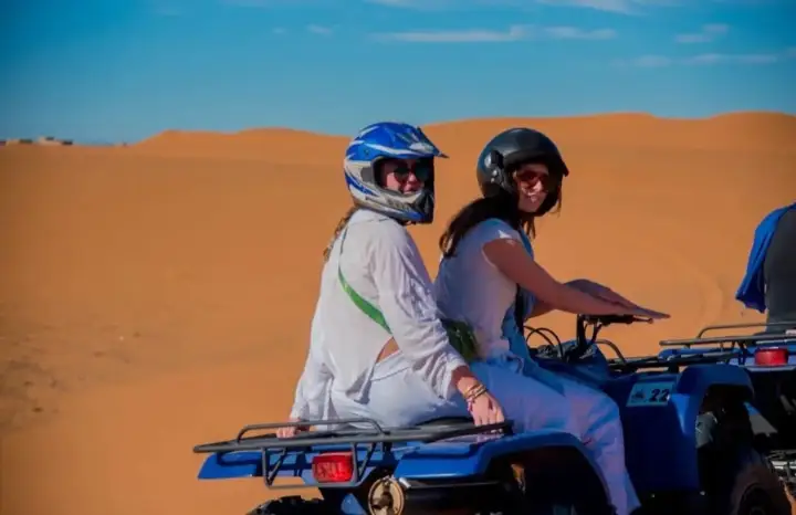 Two riders on a quad bike in the Merzouga desert