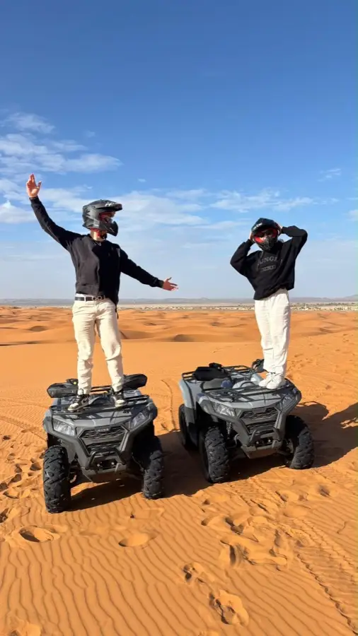 Riders standing on their quad bikes in the Merzouga desert