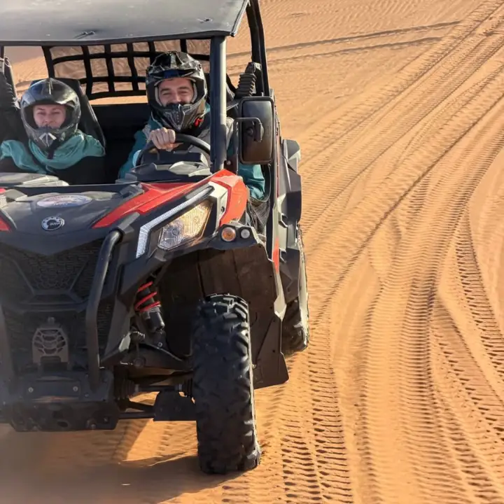 Two riders in a dune buggy on the sand tracks of Erg Chebbi