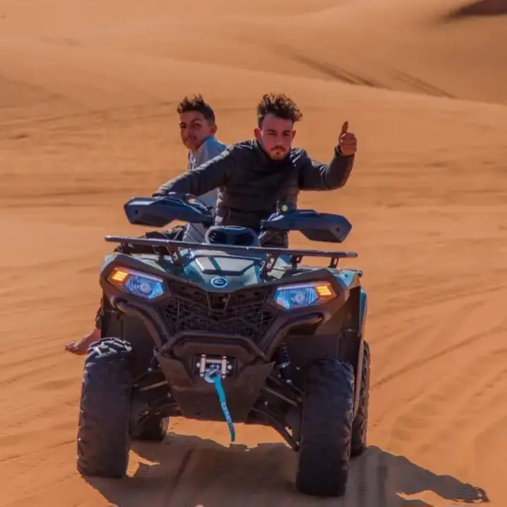Guide giving a thumbs up on a quad bike in Merzouga