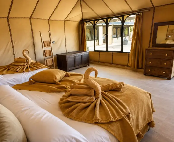 Bed inside a Berber tent at a desert camp in Merzouga