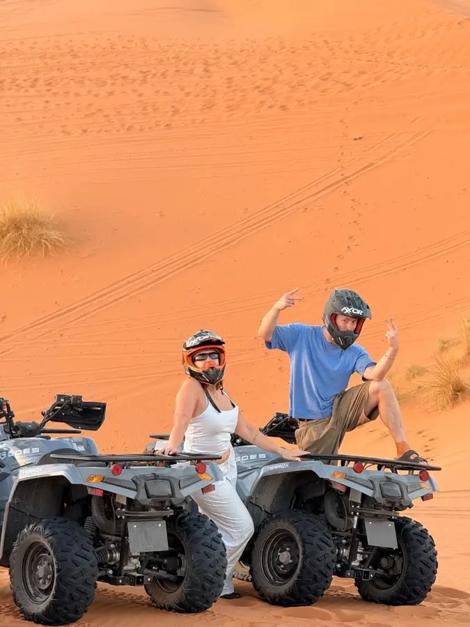 Quad riders posing on a dune near Merzouga