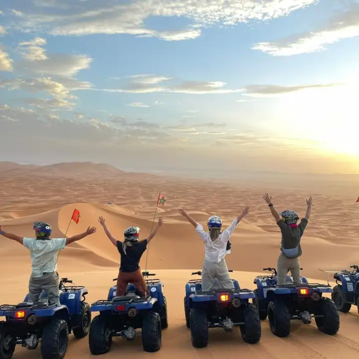 Group celebrating on top of a dune in Erg Chebbi