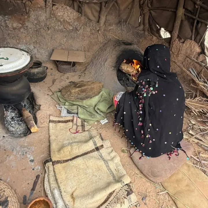 Nomad woman baking bread in her tent