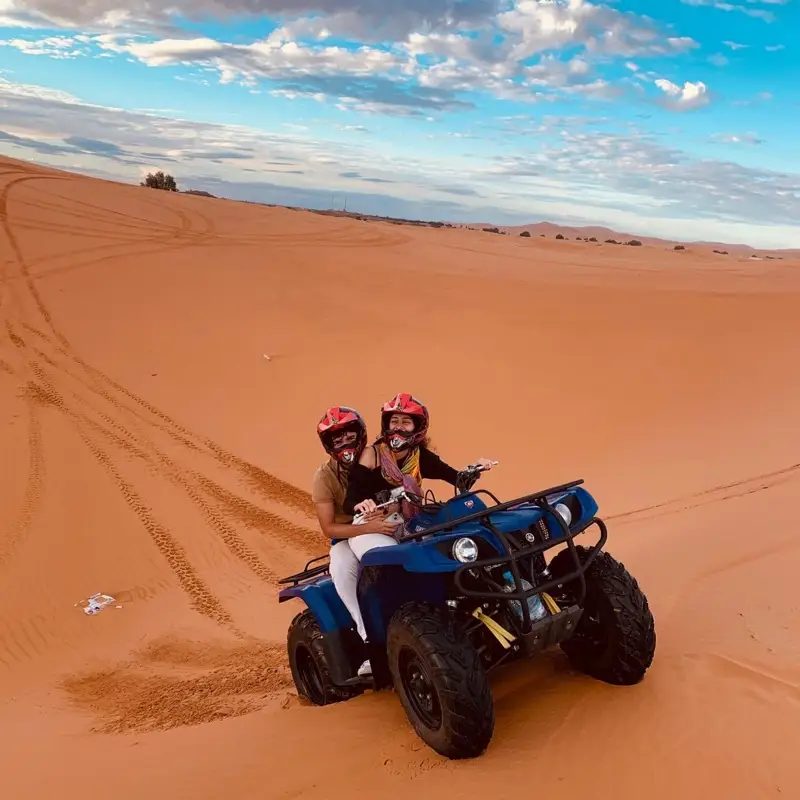 Couple on a quad among the Erg Chebbi dunes