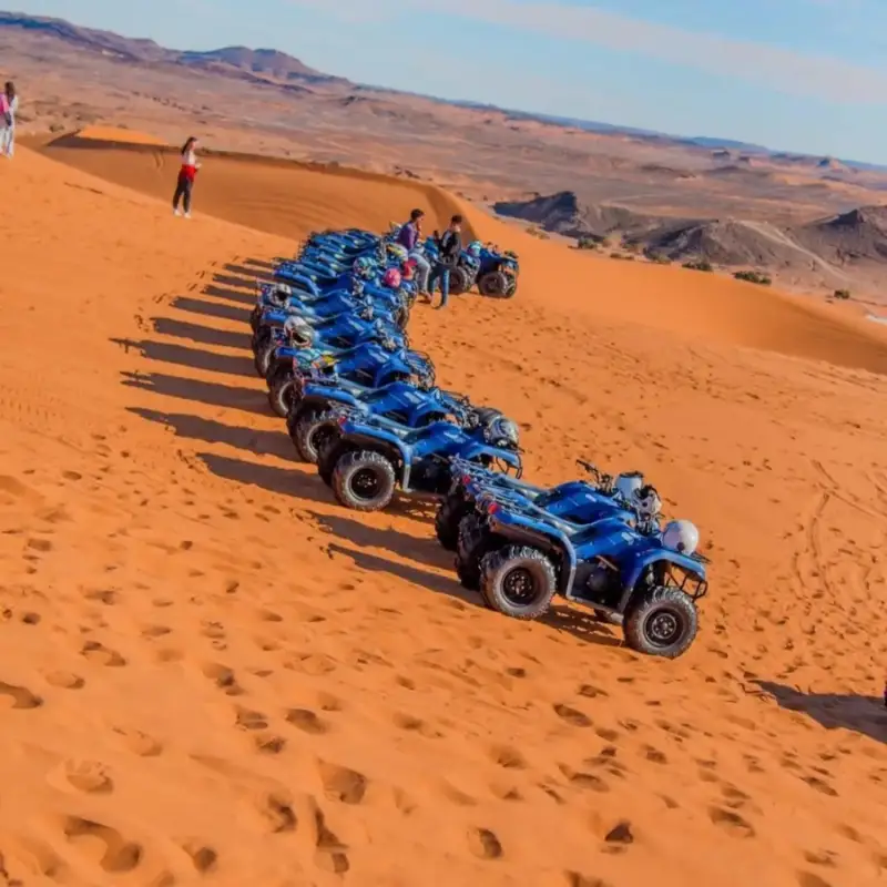 Line of quad bikes crossing the Erg Chebbi dunes